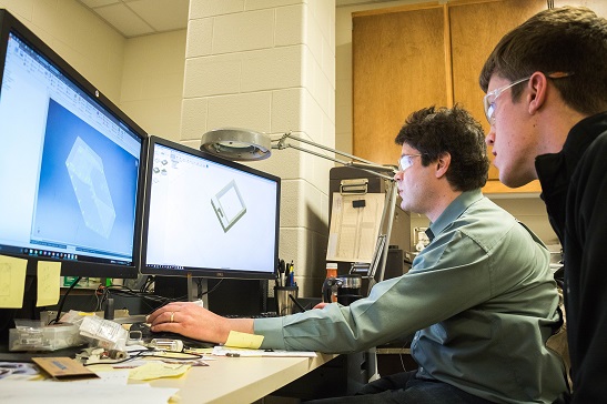 Student consulting with technician on CAD design