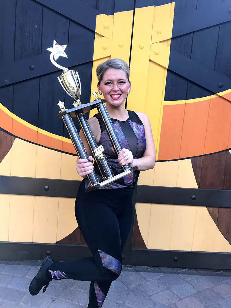 Emma holding large trophy