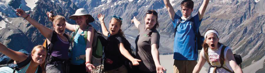 students cheering on a mountain top
