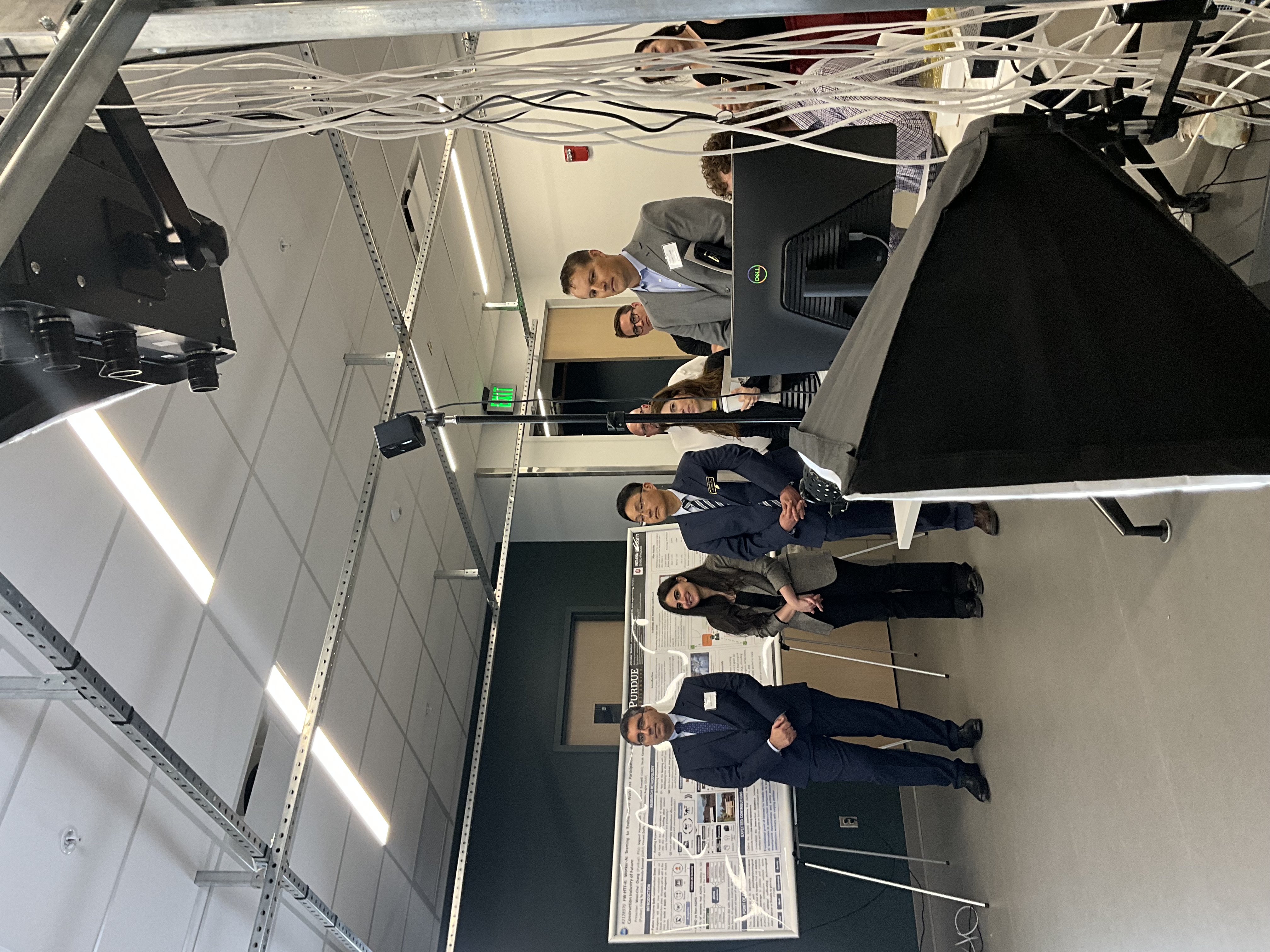 IE Faculty members Behzad Esmaeili, Reem Khir, and Young-Jun Son; James J. Solberg Head and Ransburg Professor of Industrial Engineering, look on during a demonstration of the Human Factors lab during the Gateway opening event.