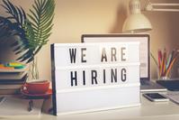 Desk scene with a light box sign on top of it, black letters read; 