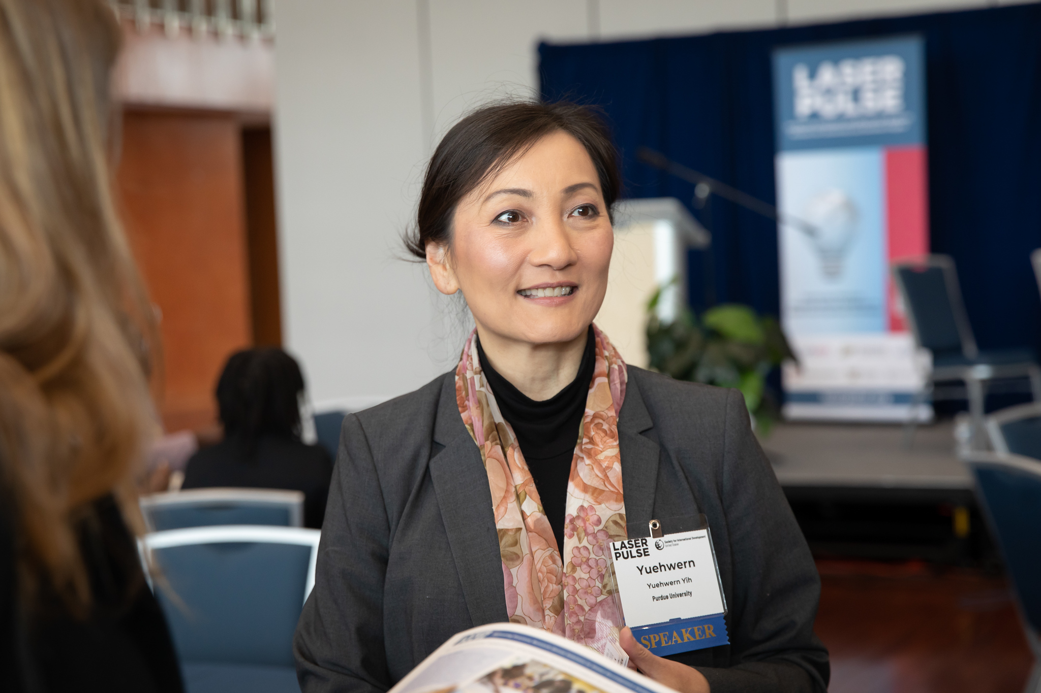 Yih speaks with attendees of the USAID Summit